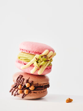 Delicious Modern Macarons With Vibrant Colors and Unique Fillings Stacked on a Clean White Background