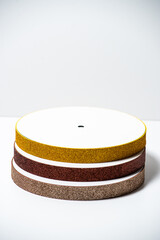 Assorted cake drum bases stacked neatly on a clean white background