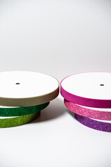 Glitter ribbons in different colors stacked together. Perfect for crafting, gift wrapping, or decoration projects