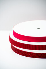 Glitter ribbons in different colors stacked together. Perfect for crafting, gift wrapping, or decoration projects