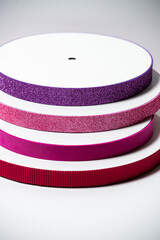 Glitter ribbons in different colors stacked together. Perfect for crafting, gift wrapping, or decoration projects
