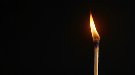 Burning match on black background