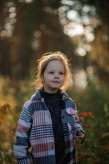 portrait of a girl, five years old, in the forest