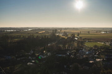 nostalgic autumn landscape with empty fields and houses