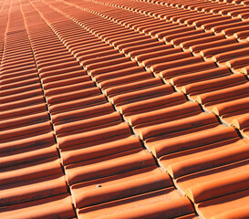 close-up of a roof built with orange-colored ceramic tiles