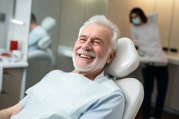 Fototapeta premium Happy elderly man with healthy teeth smiling while sitting on dentist chair during medical checkup in dental clinic