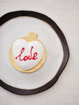 Heart-shaped Dessert Decorated With Love on a Modern Plate in a Cozy Cafe Setting