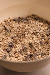 The process of preparing homemade oatmeal cookies - a mixture of dry ingredients: oatmeal, flour, dried fruit
