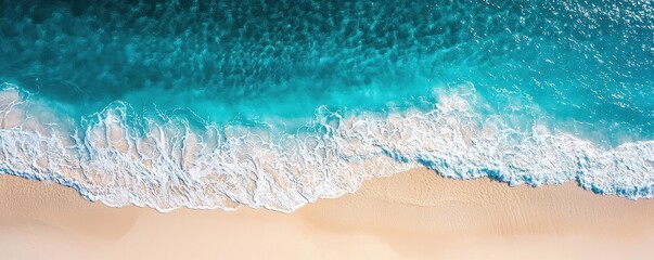 Aerial view of a vibrant beach with turquoise waters gently lapping against the sandy shore, creating a serene coastal landscape.