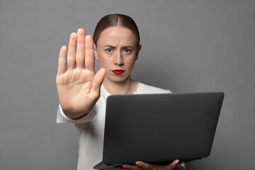 looking serious, stern, displeased and angry showing open palm making stop gesture
