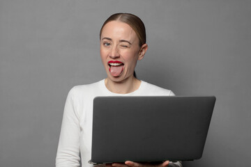 with cheerful, carefree, rebellious attitude, joking and sticking tongue out, having fun