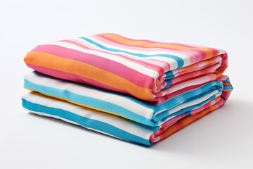 Colorful striped towels stacked neatly on a white background, ready for use at the beach or pool