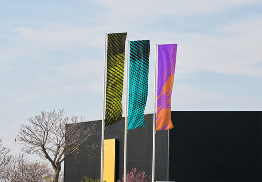 Customizable Mockup of Three Blank fly banner Flags Against a Modern Building Backdrop