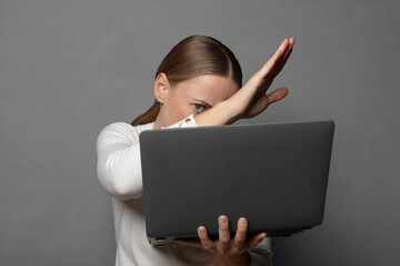 covering face with hand and putting other hand up front to stop camera, refusing photos or pictures