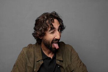 with cheerful, carefree, rebellious attitude, joking and sticking tongue out, having fun