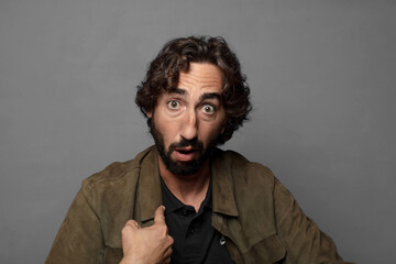 looking shocked and surprised with mouth wide open, pointing to self