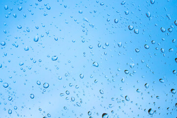 fun bright summery raindrops on a window glass