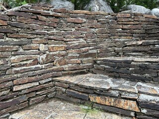 Vintage garden design and landscaping: Outdoor stairway and wall with pavement made of old nature stone tiles with gaps permeable to air and water-  ecology concept, sustainability