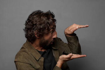 holding an object with both hands on side copy space, showing, offering or advertising an object