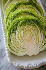 Fototapeta premium Freshly sliced cabbage reveals intricate layers and vibrant gree