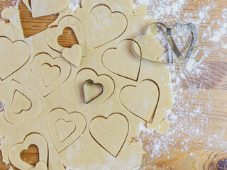 process of making heart-shaped valentine cookies and kitchen utensils
