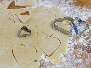 process of making heart-shaped valentine cookies and kitchen utensils