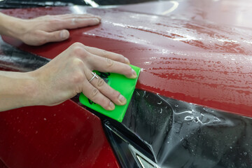 The process of installing PPF, armored film on the car. PPF is a polyurethane, protective film that...
