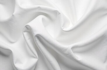 Fototapeta premium A close-up view of crumpled white fabric, showcasing intricate folds and textures. The fabric appears soft and smooth, with varying shades of white creating a dynamic visual effect