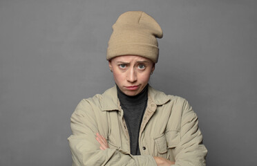 feeling displeased and disappointed, looking serious, annoyed and angry with crossed arms