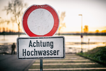 Schild an einer Straßensperrung mit Warnung vor Hochwasser
