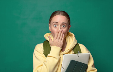 looking happy, cheerful, lucky and surprised covering mouth with both hands