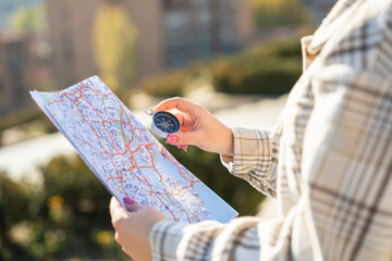 Tourist with compass and map in the city