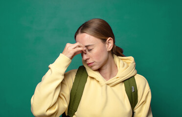 feeling stressed, unhappy and frustrated, touching forehead and suffering migraine of severe headache