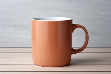 Obraz premium Orange ceramic mug on wooden table with neutral background showcasing simplicity and elegance