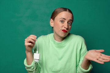 young blonde woman with a smartphone charger