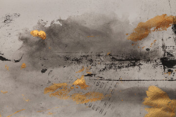 Beige, gray, gold grunge Ink watercolor brushstroke painting smear blot. Abstract grunge stain on wet beige craft paper background.
