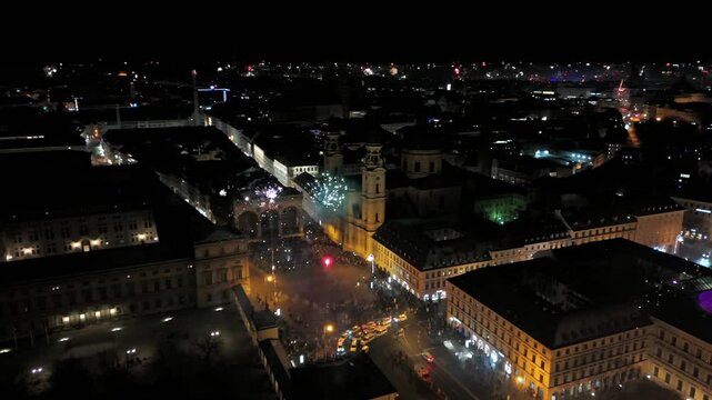 Silvester Muenchen, Deutschland, Odeonsplatz Luftaufnahme. Aerial view of Munich, Germany, showcasing vibrant New Years Eve fireworks display over city center. Stadt versinkt im Funkenregen. Salute. 