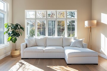 Bright living room with large windows and a comfortable white sofa