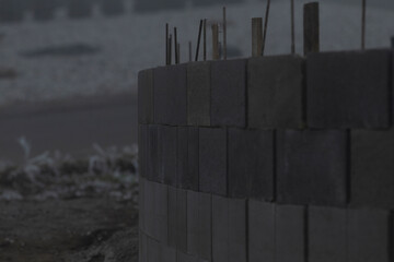 An active construction site showcasing an arrangement of stacked stone blocks alongside numerous...