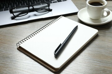 Workplace with notebook, pencil, glasses, cup of coffee, top view 
