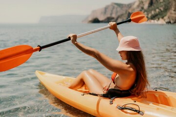 Kayak sea woman. Happy attractive woman with long hair in red swimsuit, swimming on kayak. Summer...