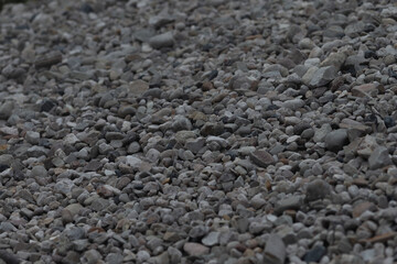 A closeup view of gravel showcasing a variety of stone sizes and shades that can be used for construction, landscaping, or other purposes