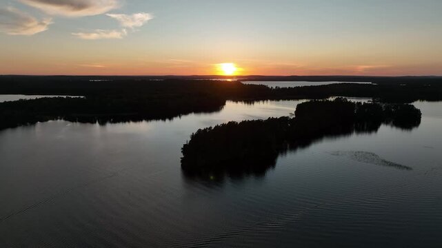 Aerial footage of the sunset over the Sodra Helgo nature reserve in Vaxjo, Kronoberg County, Sweden