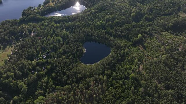 Aerial footage of the Nackern Lake surrounded by dense vegetation in Bestorp, Linkoping, Sweden