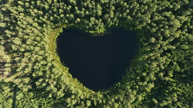 Top down aerial view of the heart-shaped Nackern Lake on a sunny day in Bestorp, Linkoping, Sweden