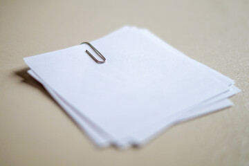 Stack of White Papers with a Paperclip
