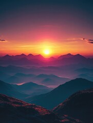 Fototapeta premium Beautiful sunset over a mountain range with a large sun in the sky. The sky is a mix of orange and pink colors, creating a serene and peaceful atmosphere