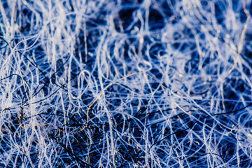 Macrophotography of synthetic fabric, microplastic, acrylic fabric.