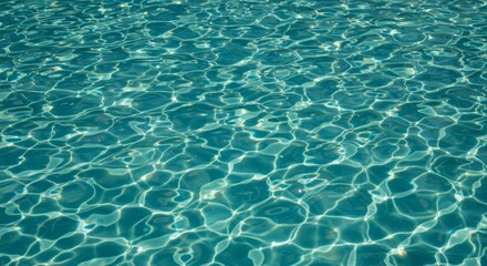 Obraz premium Close-up top view of calm pool water with gentle, soft ripples and light reflections, creating a serene and peaceful water surface for background use.