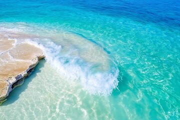 Turquoise wave crashes on white sand beach